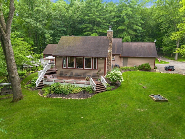 8622 Lott Rd, Marengo, OH 43334 - view of front of house with a deck, stairway, a chimney, a front lawn, and a shingled roof