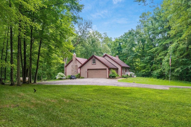 8622 Lott Rd, Marengo, OH 43334 - view of front facade featuring a garage, asphalt driveway, a front yard, a chimney, and a view of trees