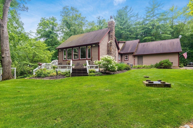 8622 Lott Rd, Marengo, OH 43334 - view of front of property with a front lawn, an outdoor fire pit, a chimney, and a shingled roof