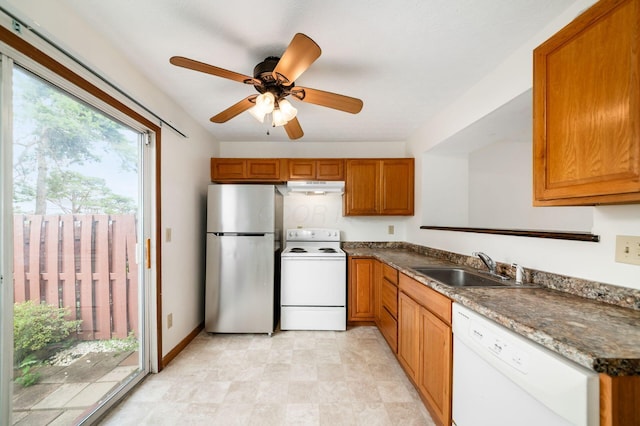 884 Annagladys Dr Unit F2, Columbus, OH 43085 - kitchen with white appliances, under cabinet range hood, brown cabinetry, and a ceiling fan