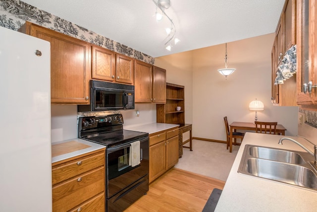 154 Oak Creek Pl, Columbus, OH 43230 - kitchen featuring black appliances, light countertops, brown cabinetry, and light wood-type flooring