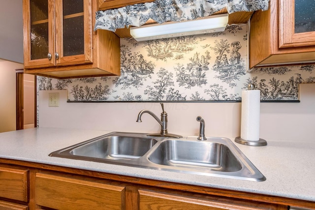 154 Oak Creek Pl, Columbus, OH 43230 - kitchen featuring brown cabinetry, light countertops, and glass insert cabinets