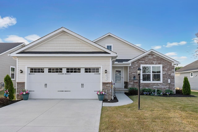 211 Talla Rd S, Delaware, OH 43015 - view of front facade featuring an attached garage, stone siding, driveway, and a front yard
