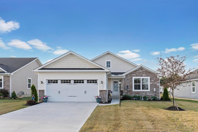 211 Talla Rd S, Delaware, OH 43015 - view of front of house featuring a garage, a front yard, concrete driveway, and stone siding