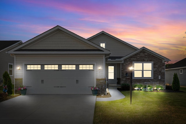 211 Talla Rd S, Delaware, OH 43015 - traditional-style home with stone siding, concrete driveway, a front lawn, and an attached garage
