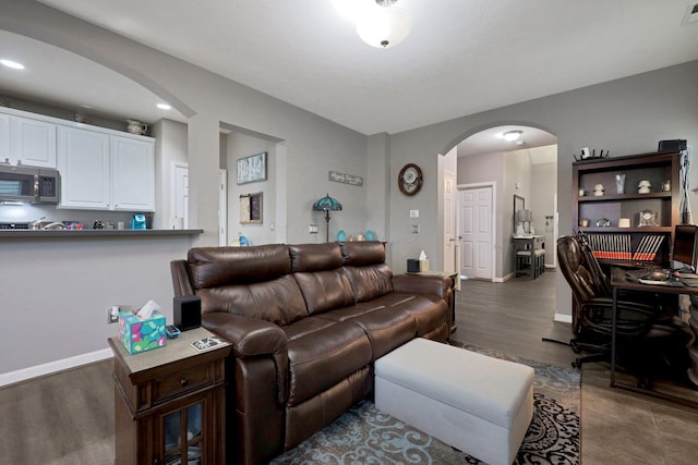 7911 Ashenden Dr, Blacklick, OH 43004 - living area with arched walkways, wood finished floors, a desk, and recessed lighting
