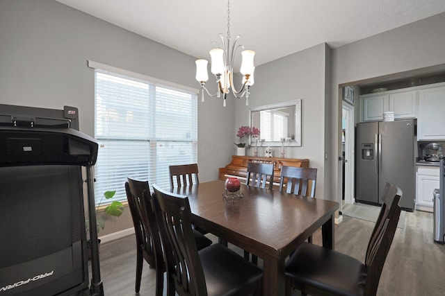 7911 Ashenden Dr, Blacklick, OH 43004 - dining space featuring light wood-style floors and a chandelier