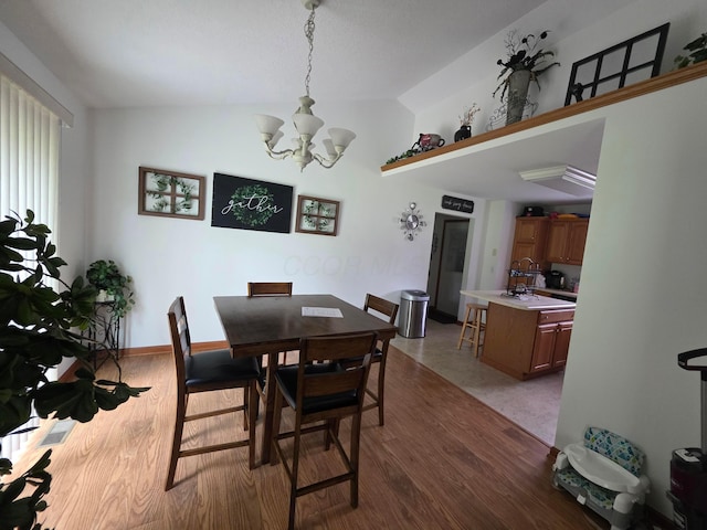 1919 Jared Pl, Lima, OH 45805 - dining area featuring a chandelier, lofted ceiling, and wood finished floors