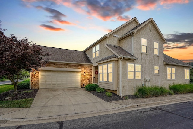 1013 Bluff Crest Dr, Columbus, OH 43235 - traditional-style home with stucco siding, a garage, driveway, and stone siding