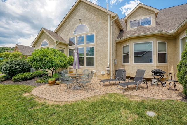 1013 Bluff Crest Dr, Columbus, OH 43235 - rear view of property with a patio area, a lawn, and stucco siding