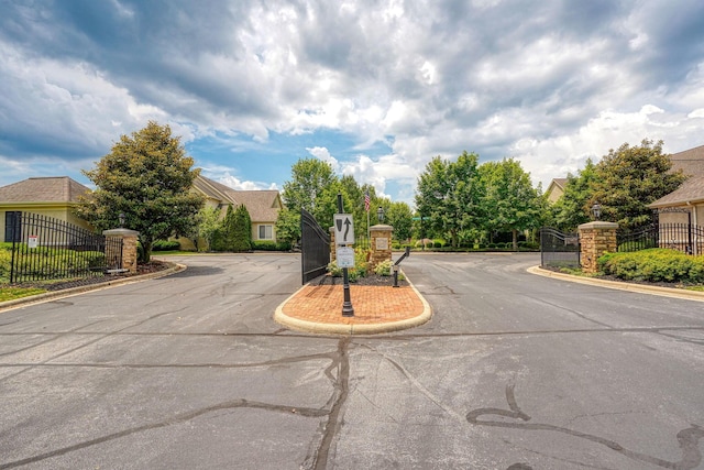 1013 Bluff Crest Dr, Columbus, OH 43235 - view of asphalt street with a gated entry, curbs, and a gate