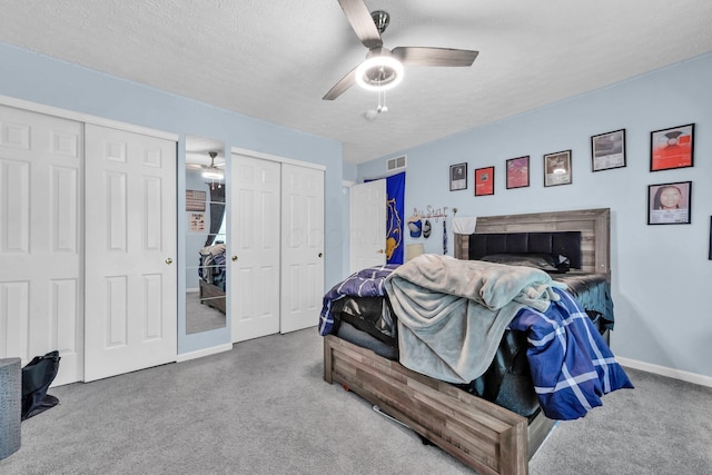 6598 Estate View Dr S, Blacklick, OH 43004 - carpeted bedroom with multiple closets, a ceiling fan, and a textured ceiling