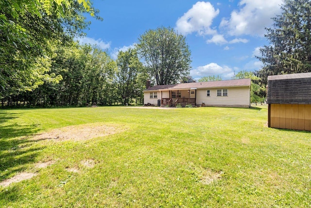 7472 Davis Rd, Hilliard, OH 43026 - view of grassy yard with a storage shed and a deck