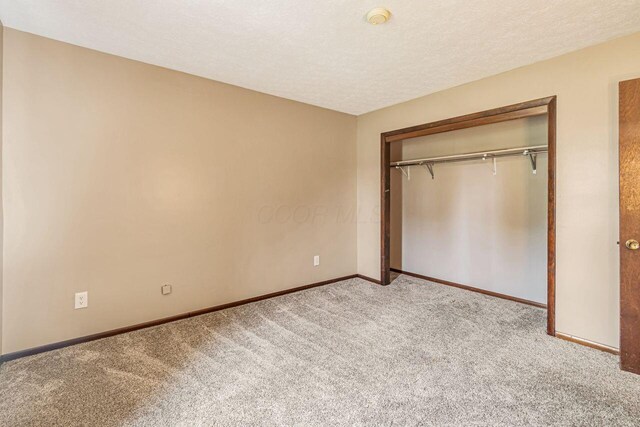 7472 Davis Rd, Hilliard, OH 43026 - unfurnished bedroom with carpet floors, a closet, and a textured ceiling