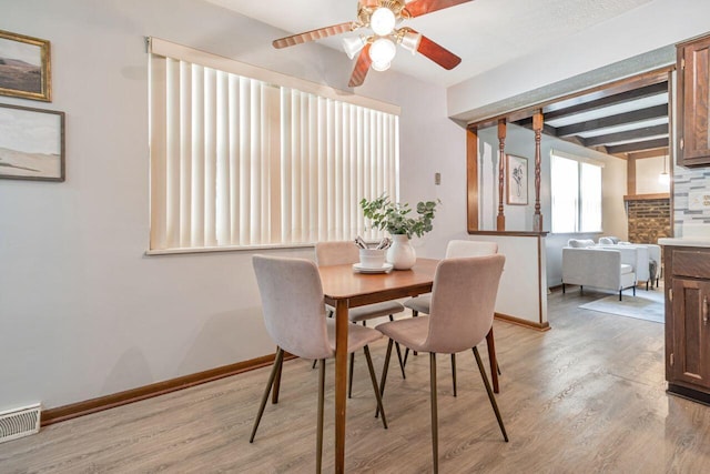 7472 Davis Rd, Hilliard, OH 43026 - dining area featuring light wood-style floors, a ceiling fan, and beam ceiling