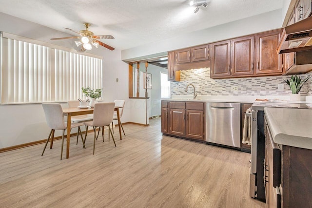 7472 Davis Rd, Hilliard, OH 43026 - kitchen featuring dishwasher, range, light countertops, light wood finished floors, and a ceiling fan