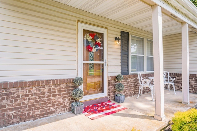 7472 Davis Rd, Hilliard, OH 43026 - doorway to property featuring a porch and brick siding