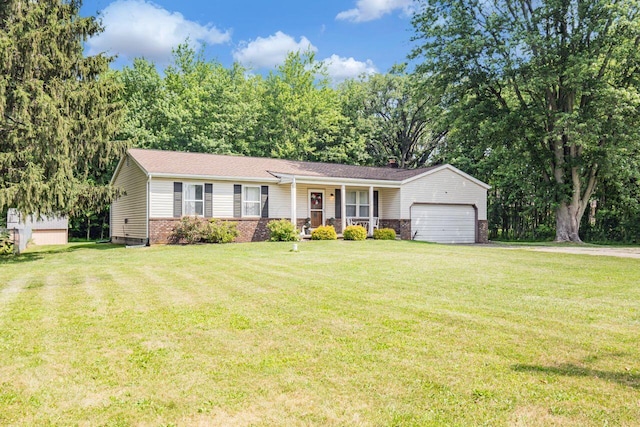7472 Davis Rd, Hilliard, OH 43026 - ranch-style house with a porch, a garage, brick siding, and a front yard