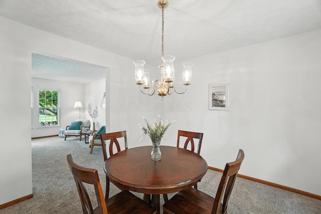 526 Springwood Lake Dr, Columbus, OH 43230 - carpeted dining room with a chandelier and baseboards