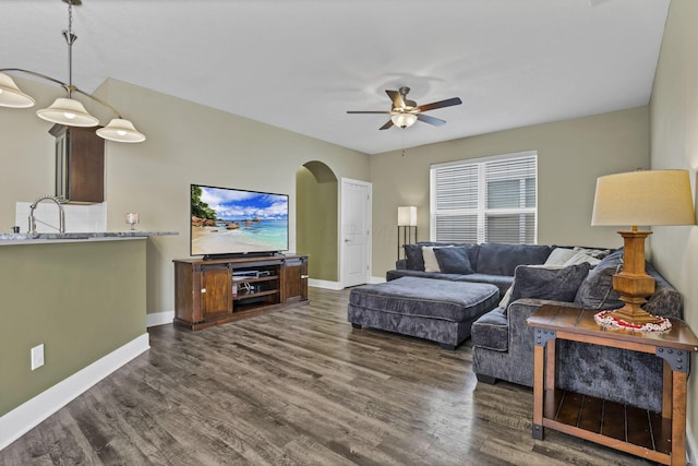 68 Asbury Ave, Newark, OH 43055 - living area with arched walkways, ceiling fan, and dark wood finished floors
