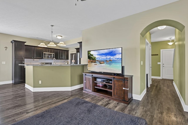 68 Asbury Ave, Newark, OH 43055 - living room featuring dark wood-style flooring, arched walkways, and ceiling fan