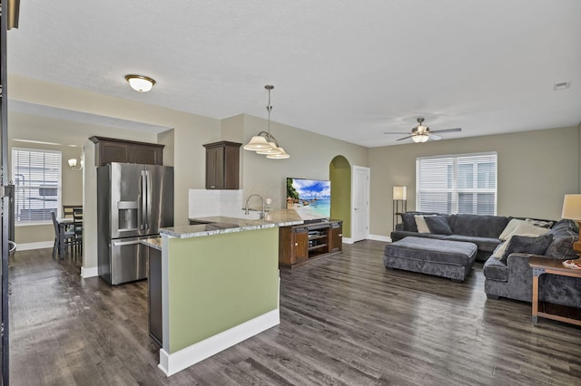 68 Asbury Ave, Newark, OH 43055 - kitchen featuring stainless steel refrigerator with ice dispenser, a peninsula, a ceiling fan, dark brown cabinets, and arched walkways