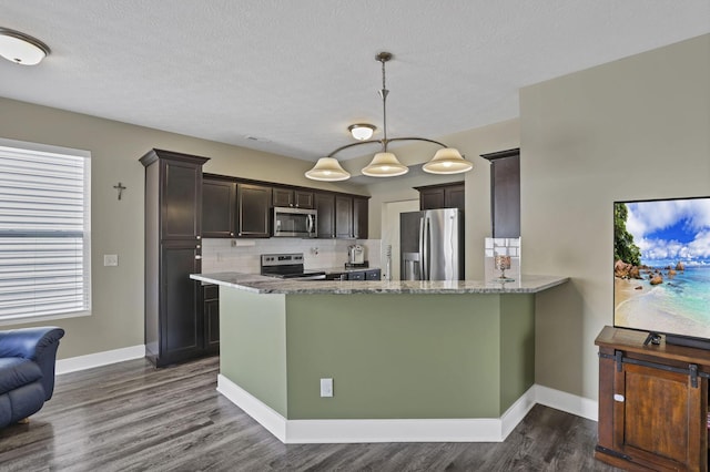 68 Asbury Ave, Newark, OH 43055 - kitchen with stainless steel appliances, light stone counters, dark wood finished floors, dark brown cabinets, and decorative backsplash