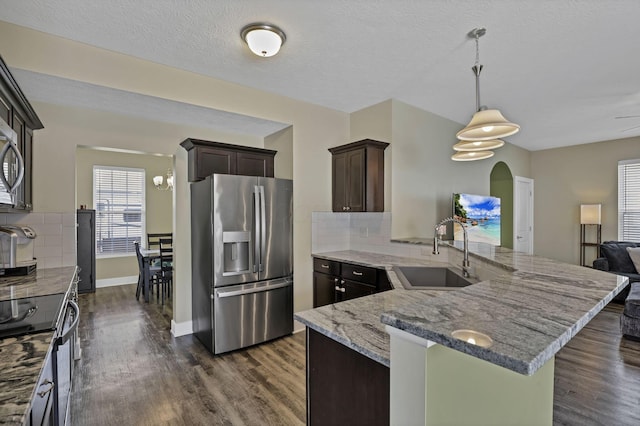 68 Asbury Ave, Newark, OH 43055 - kitchen featuring appliances with stainless steel finishes, dark brown cabinets, backsplash, dark wood finished floors, and a peninsula