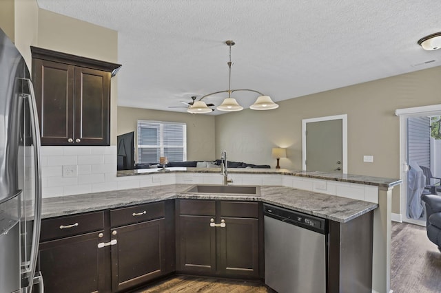 68 Asbury Ave, Newark, OH 43055 - kitchen featuring stainless steel appliances, wood finished floors, dark brown cabinetry, a textured ceiling, and a peninsula