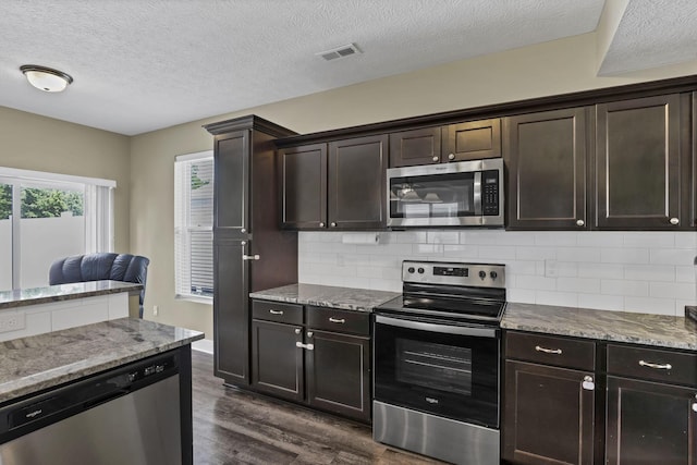 68 Asbury Ave, Newark, OH 43055 - kitchen featuring appliances with stainless steel finishes, dark wood-style flooring, backsplash, light stone countertops, and a textured ceiling