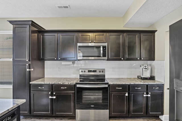 68 Asbury Ave, Newark, OH 43055 - kitchen featuring stainless steel appliances, backsplash, light stone counters, a textured ceiling, and dark brown cabinetry