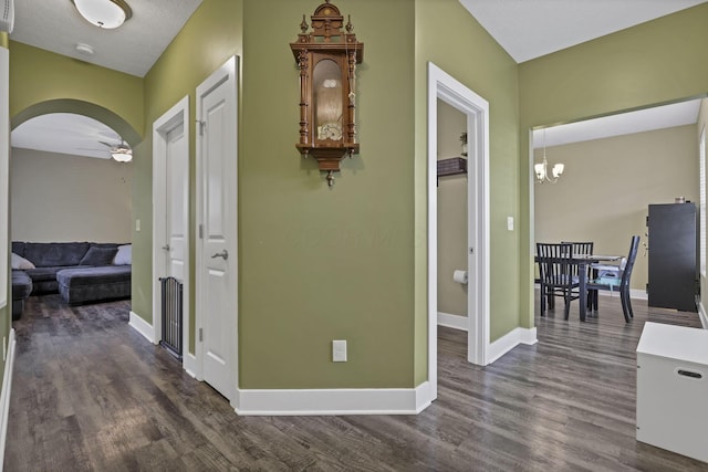 68 Asbury Ave, Newark, OH 43055 - hall featuring dark wood-type flooring, arched walkways, and a chandelier