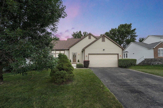 1691 Cloverdale Dr, Lancaster, OH 43130 - view of front of property featuring asphalt driveway, a garage, and a yard