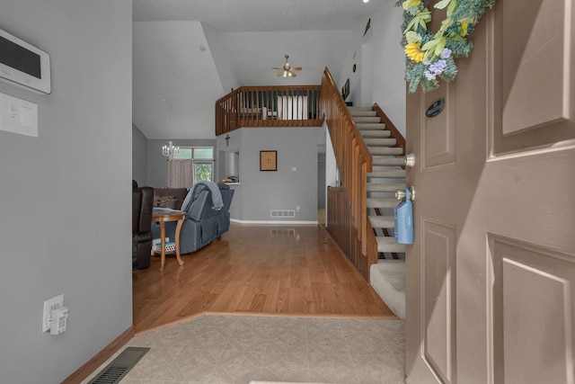 1691 Cloverdale Dr, Lancaster, OH 43130 - entrance foyer with ceiling fan, stairway, wood finished floors, and a chandelier