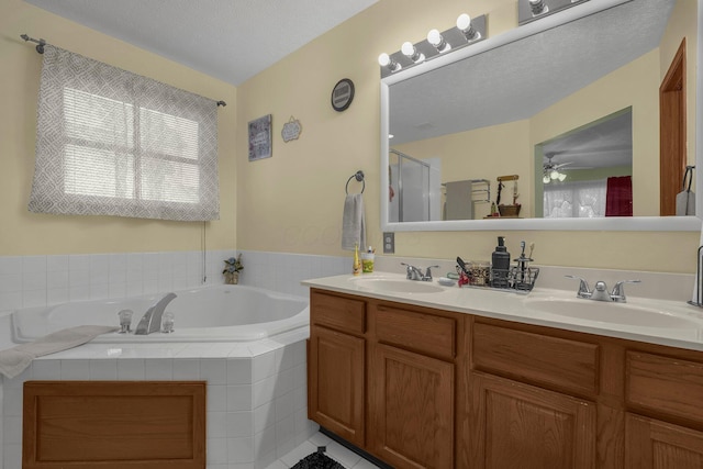 1691 Cloverdale Dr, Lancaster, OH 43130 - bathroom with double vanity, a bath, a stall shower, and a ceiling fan