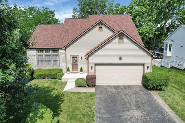 1691 Cloverdale Dr, Lancaster, OH 43130 - view of front of house featuring asphalt driveway, a front lawn, roof with shingles, and a garage