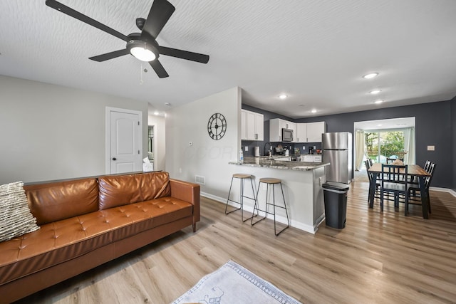 1815 Union St, Lancaster, OH 43130 - living room featuring light wood finished floors, ceiling fan, and recessed lighting