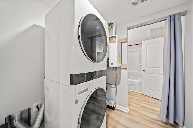 1815 Union St, Lancaster, OH 43130 - laundry area with stacked washer / dryer, water heater, and light wood-type flooring