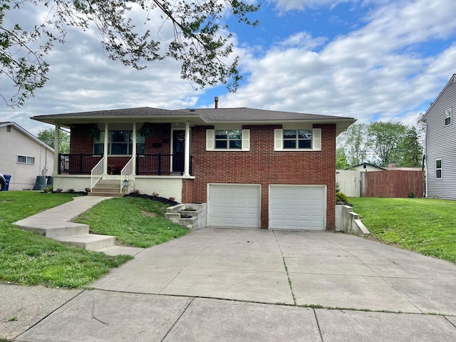 1492 Cottonwood Dr, Columbus, OH 43229 - view of front facade featuring brick siding, an attached garage, a porch, and concrete driveway