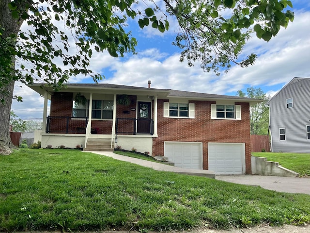 1492 Cottonwood Dr, Columbus, OH 43229 - view of front of house with brick siding, a garage, a front yard, covered porch, and driveway