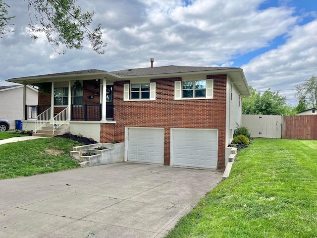 1492 Cottonwood Dr, Columbus, OH 43229 - view of front of house featuring a garage, concrete driveway, brick siding, a gate, and covered porch