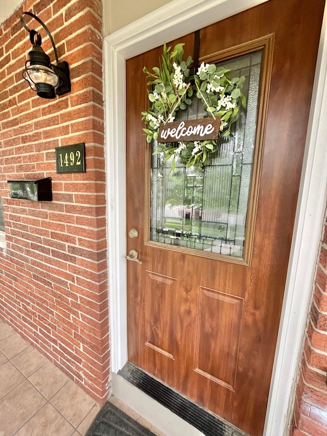 1492 Cottonwood Dr, Columbus, OH 43229 - view of exterior entry featuring brick siding