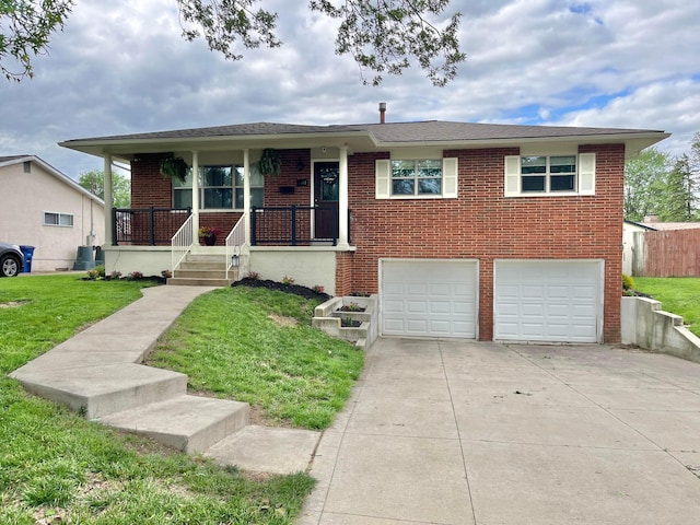 1492 Cottonwood Dr, Columbus, OH 43229 - view of front of home with concrete driveway, brick siding, a front yard, a garage, and covered porch