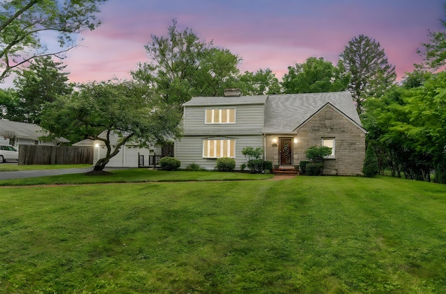 1054 Highland Dr, Columbus, OH 43220 - view of front facade featuring a chimney and asphalt driveway