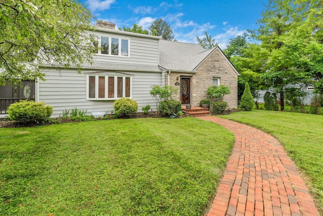 1054 Highland Dr, Columbus, OH 43220 - view of front of property with a front lawn, stone siding, a shingled roof, and a chimney