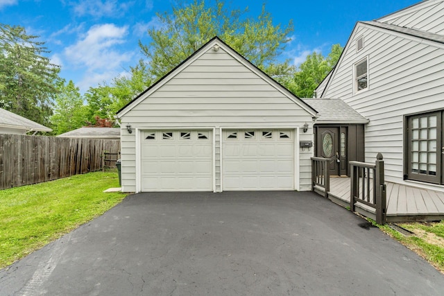 1054 Highland Dr, Columbus, OH 43220 - view of front facade with asphalt driveway, a wooden deck, and a garage