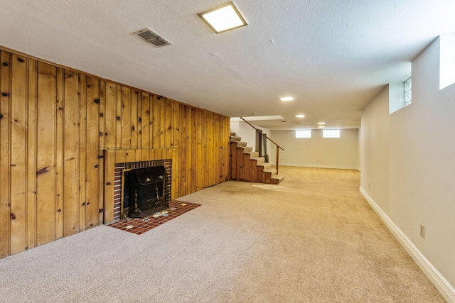 1054 Highland Dr, Columbus, OH 43220 - unfurnished living room with stairway, carpet flooring, wooden walls, a brick fireplace, and a textured ceiling
