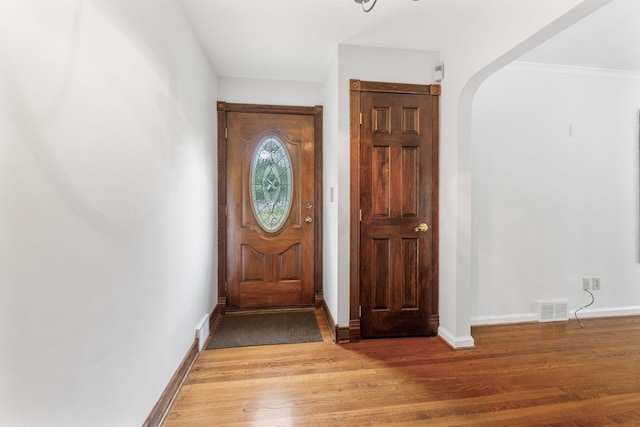 1054 Highland Dr, Columbus, OH 43220 - foyer featuring light wood-type flooring and arched walkways