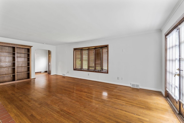 1054 Highland Dr, Columbus, OH 43220 - unfurnished bedroom with arched walkways, crown molding, and wood finished floors