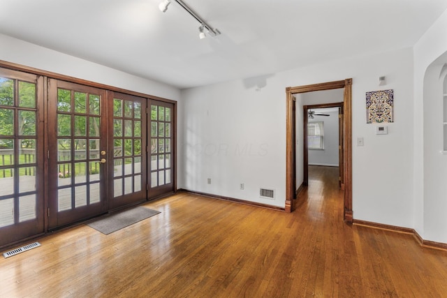 1054 Highland Dr, Columbus, OH 43220 - doorway to outside with track lighting, wood finished floors, arched walkways, and french doors